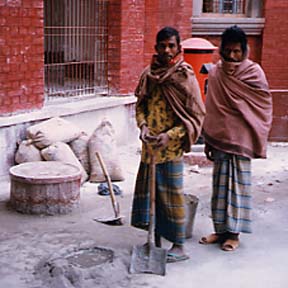 Workers mixing cement